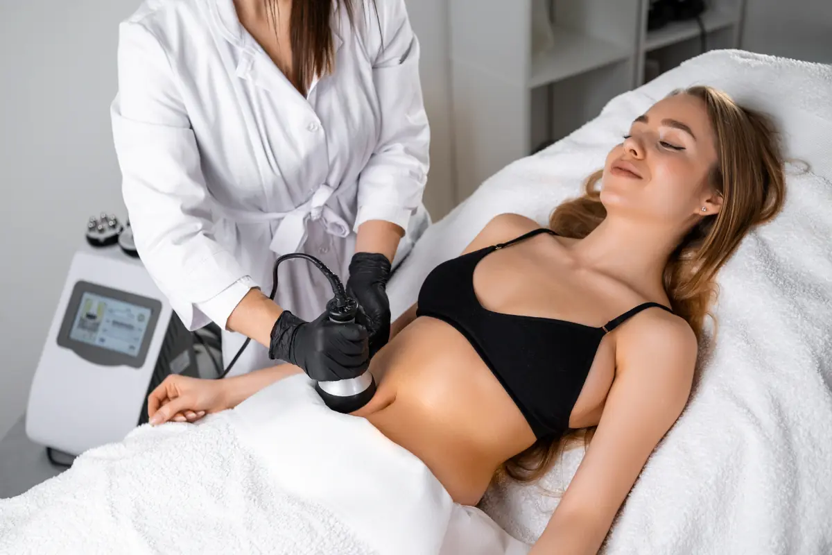 Young women receiving a VASER Shape body contouring treatment from a medical professional.